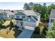 Well-maintained two-story home featuring solar panels, a porch, and attractive landscaping at 105 Blue Prince Trl, Holly Springs, NC 27540