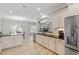 Spacious kitchen with stainless steel appliances, white cabinets, granite countertops and wood-look flooring at 105 Blue Prince Trl, Holly Springs, NC 27540