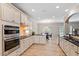 Updated kitchen with white cabinets, black countertops, stainless appliances, and view to dining area at 105 Blue Prince Trl, Holly Springs, NC 27540