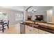 Open kitchen view to Gathering room with a granite countertop, stainless steel appliances and wood floors at 105 Blue Prince Trl, Holly Springs, NC 27540