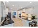 Bright kitchen with white cabinets, sleek black countertops, stainless steel appliances and wood-look floors at 105 Blue Prince Trl, Holly Springs, NC 27540