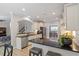 Open kitchen area with white cabinets, black countertops, stainless appliances and a breakfast bar with seating at 105 Blue Prince Trl, Holly Springs, NC 27540