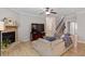 Spacious living room featuring a stone fireplace, hardwood floors, and staircase leading to upper level at 105 Blue Prince Trl, Holly Springs, NC 27540
