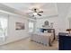 Serene main bedroom with tray ceiling, a ceiling fan, carpeted floor and natural light from the windows at 105 Blue Prince Trl, Holly Springs, NC 27540