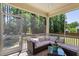 Relaxing screened porch with comfortable seating and views of the lush backyard and natural sunlight at 105 Blue Prince Trl, Holly Springs, NC 27540