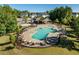 Community pool with ample seating and a covered area surrounded by lush greenery and well-maintained landscaping at 105 Blue Prince Trl, Holly Springs, NC 27540