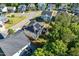 Aerial view of a home featuring solar panels on the roof, a well-manicured lawn, and neighboring houses at 105 Blue Prince Trl, Holly Springs, NC 27540