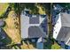 Aerial view of a roof with solar panels, surrounded by a well-maintained yard and neighboring properties at 105 Blue Prince Trl, Holly Springs, NC 27540