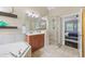 Bathroom with a soaking tub, glass shower, and a view into the bedroom at 10523 Bedfordtown Dr, Raleigh, NC 27614