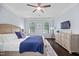 Comfortable bedroom featuring a plush bed, TV, and natural lighting from two windows at 10523 Bedfordtown Dr, Raleigh, NC 27614