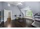 A spacious bonus room features hardwood floors, a ceiling fan and arched window seat with natural light at 10523 Bedfordtown Dr, Raleigh, NC 27614