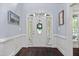 Inviting entryway with a decorative front door, sidelights, dark wood flooring and traditional trim work and natural light at 10523 Bedfordtown Dr, Raleigh, NC 27614