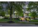 Elegant two-story home with a charming front porch, lush landscaping, and classic architectural details at 10523 Bedfordtown Dr, Raleigh, NC 27614