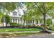 Traditional two-story home with a inviting front porch and mature trees gracing the yard at 10523 Bedfordtown Dr, Raleigh, NC 27614