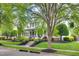 Charming two-story home featuring a welcoming front porch, complemented by beautiful landscaping at 10523 Bedfordtown Dr, Raleigh, NC 27614