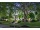 Charming two-story home with a inviting front porch and beautiful landscaping at dusk at 10523 Bedfordtown Dr, Raleigh, NC 27614