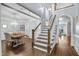 Elegant foyer featuring a staircase, a dining room with chandelier, and beautiful hardwood floors at 10523 Bedfordtown Dr, Raleigh, NC 27614