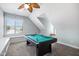 Second story game room with pool table, large window, and additional window seat for relaxing at 10523 Bedfordtown Dr, Raleigh, NC 27614