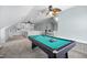 Spacious game room with pool table, bar seating, built in shelves, and neutral carpet at 10523 Bedfordtown Dr, Raleigh, NC 27614