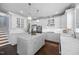 Well-lit kitchen offers white cabinets, stainless steel appliances, and a large center island at 10523 Bedfordtown Dr, Raleigh, NC 27614