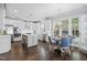 Spacious kitchen with white cabinets, stainless steel appliances, center island, eat-in table and hardwood floors at 10523 Bedfordtown Dr, Raleigh, NC 27614