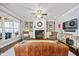 Open living room with fireplace, built-ins, large windows, providing a comfortable and inviting space for relaxation at 10523 Bedfordtown Dr, Raleigh, NC 27614