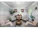 Charming living room featuring comfortable seating, unique decor, paneling, and natural light offering a relaxing space at 10523 Bedfordtown Dr, Raleigh, NC 27614