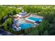 Aerial view of a community pool with separate areas for lap swimming and leisure, surrounded by lush greenery at 10523 Bedfordtown Dr, Raleigh, NC 27614