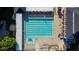 Aerial view of an Olympic-size community pool, featuring neatly arranged lounge chairs and shady cabanas at 10523 Bedfordtown Dr, Raleigh, NC 27614