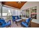 Inviting screened porch with ceiling fan, comfortable furniture, and white curtains for privacy at 10523 Bedfordtown Dr, Raleigh, NC 27614