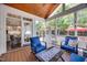 Relaxing screened porch with wood ceiling, outdoor furniture, and views of the backyard at 10523 Bedfordtown Dr, Raleigh, NC 27614