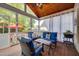 Cozy screened-in porch with wood floors, comfortable seating, and backyard views at 10523 Bedfordtown Dr, Raleigh, NC 27614