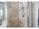 Shower with tiled walls and glass enclosure with a glimpse of the Primary bedroom at 10523 Bedfordtown Dr, Raleigh, NC 27614