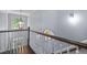 Elegant stairway with natural lighting, decorative light fixture, and railing at 10523 Bedfordtown Dr, Raleigh, NC 27614