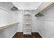A well-organized walk-in closet boasts built in shelving, hardwood floors, and hanging rods at 10523 Bedfordtown Dr, Raleigh, NC 27614