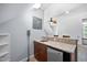 Bonus room wet bar area with mini fridge, wood cabinets, granite counters, and built in shelves at 10523 Bedfordtown Dr, Raleigh, NC 27614