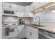 Well-lit kitchen features granite countertops, white cabinets and appliances, and subway tile backsplash at 11 Providence Ct, Durham, NC 27705