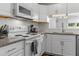Bright kitchen with white cabinets, granite countertops, white appliances, and subway tile backsplash at 11 Providence Ct, Durham, NC 27705