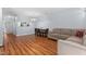 Open-concept living room with wood floors, dining area, and view into the kitchen through a pass-through at 11 Providence Ct, Durham, NC 27705