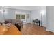 Spacious living room with wood floors, and a piano and large window with a view of greenery at 11 Providence Ct, Durham, NC 27705