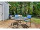 Outdoor patio with seating, surrounded by a well-maintained lawn and trees at 11 Providence Ct, Durham, NC 27705