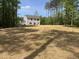 Backyard showing a spacious, newly seeded lawn of a home backing onto a wooded area at 110 Cribbs Ln, Middlesex, NC 27557