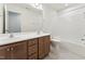 Bathroom with double sinks, wood cabinets, a large mirror, and a shower/tub combo at 110 Cribbs Ln, Middlesex, NC 27557
