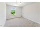 A naturally lit bedroom offers neutral carpet and a beautiful view of a tree-lined yard at 110 Cribbs Ln, Middlesex, NC 27557