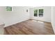 Spacious bedroom features hardwood floors, bright windows, and white walls at 110 Cribbs Ln, Middlesex, NC 27557