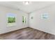 Bright bedroom featuring hardwood floors and abundant natural light from three windows at 110 Cribbs Ln, Middlesex, NC 27557
