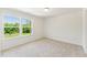 A bedroom features natural light, neutral carpet and a great view of a tree-lined yard at 110 Cribbs Ln, Middlesex, NC 27557