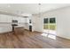 Modern kitchen with white cabinets, stainless appliances, island, and sliding glass doors to deck at 110 Cribbs Ln, Middlesex, NC 27557