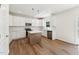 Modern kitchen featuring white cabinets, stainless appliances, a center island, and hardwood floors at 110 Cribbs Ln, Middlesex, NC 27557