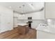 Modern kitchen featuring white cabinets, stainless appliances, a center island and hardwood floors at 110 Cribbs Ln, Middlesex, NC 27557